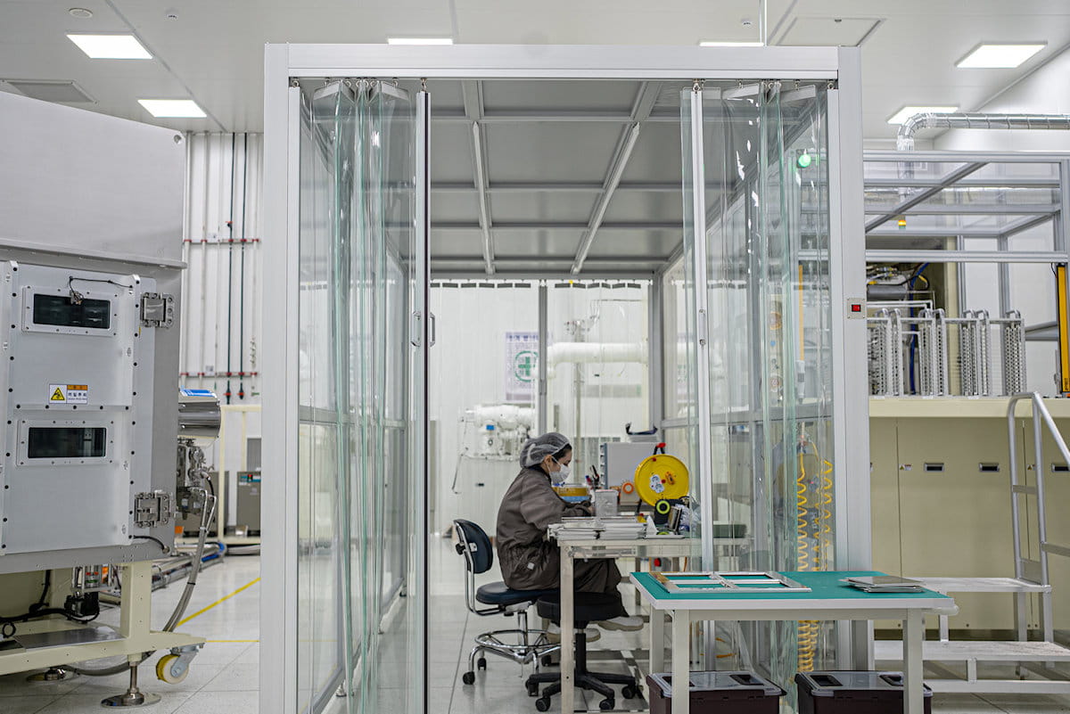 SELCOS engineer performing maintenance inside a cleanroom